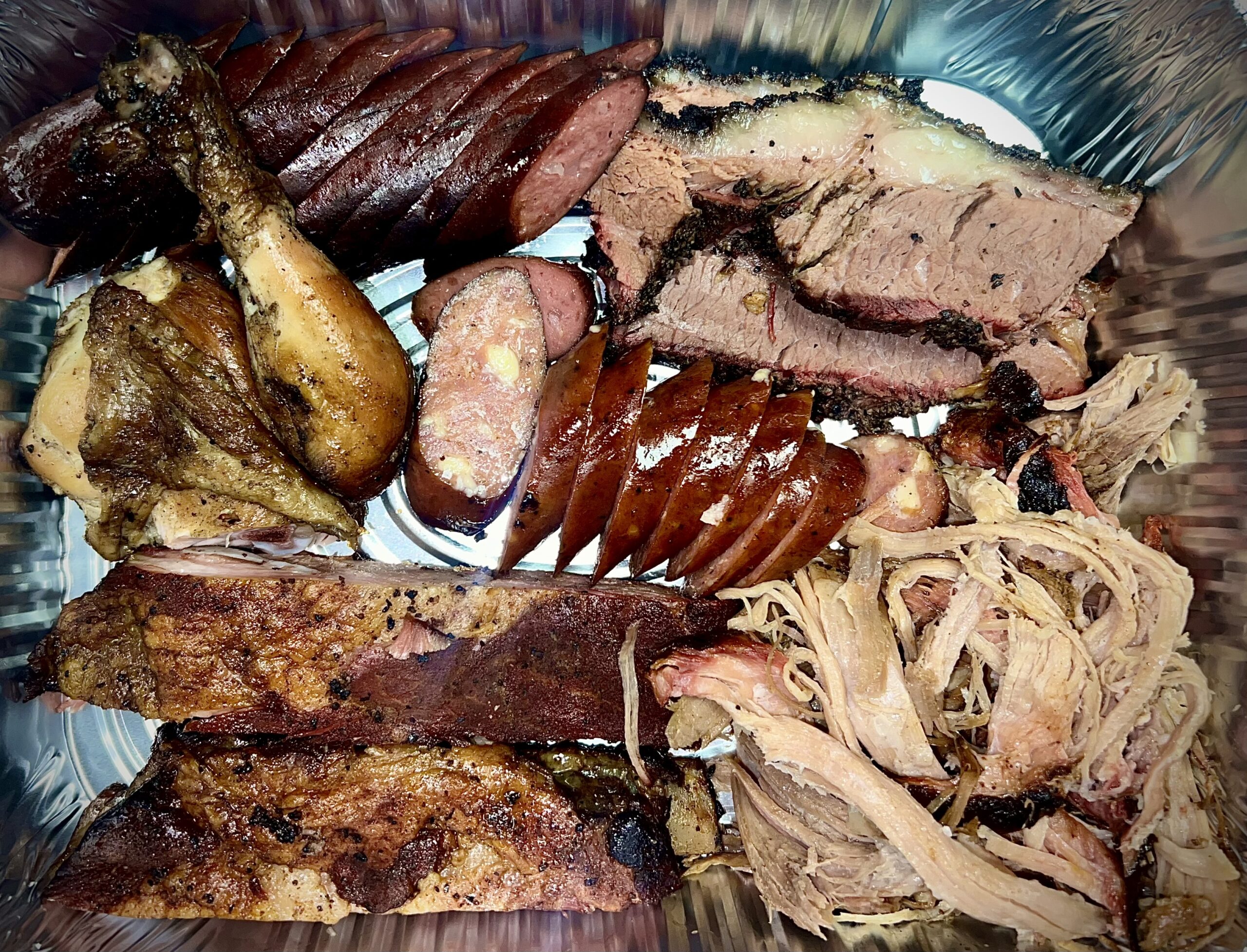 Meats-OKSmokeBBQ - Oklahoma Smoke BBQ BBQ assorted food.