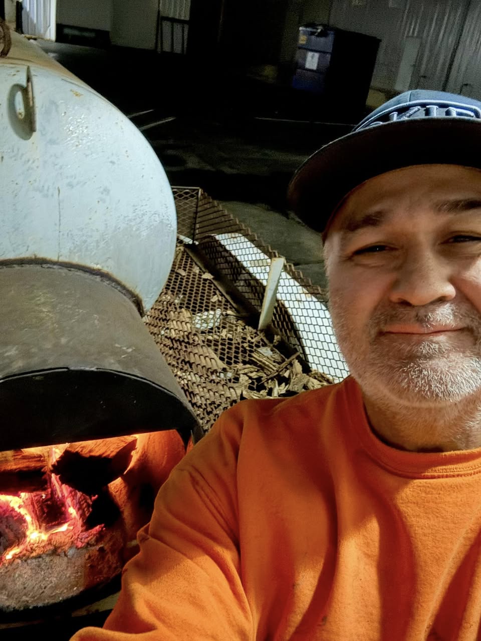 Brent Quintero one of the founders standing by a smoker.